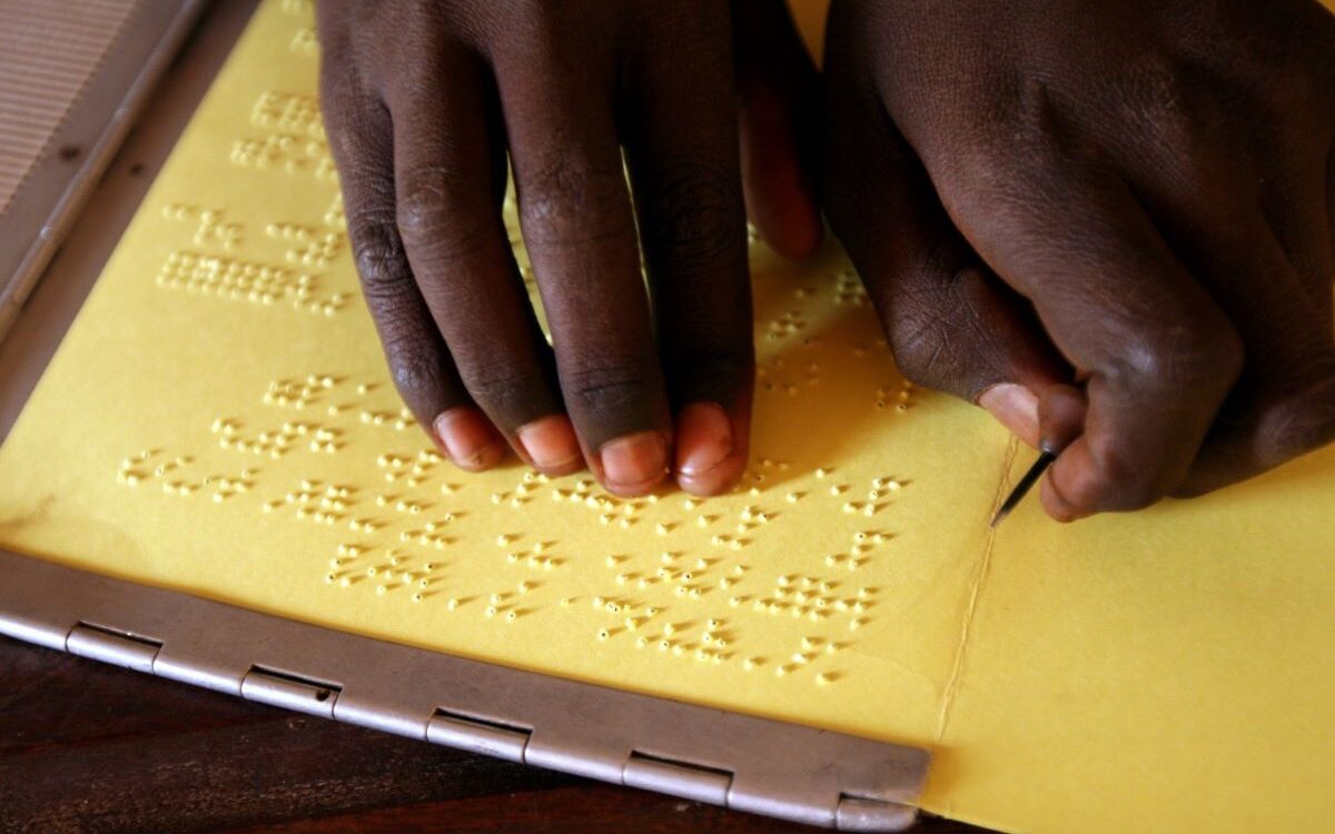 A girl writes braille with a stylus during a lesson in Mali.