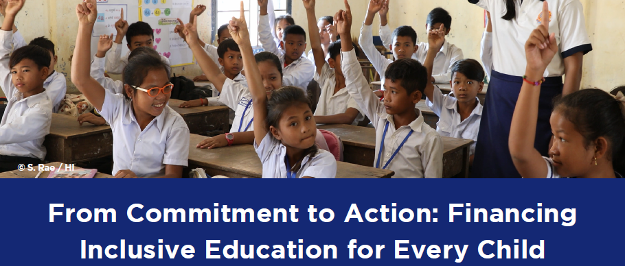 Pupils in a classroom raising their hands